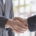 2 Business men shaking hands.